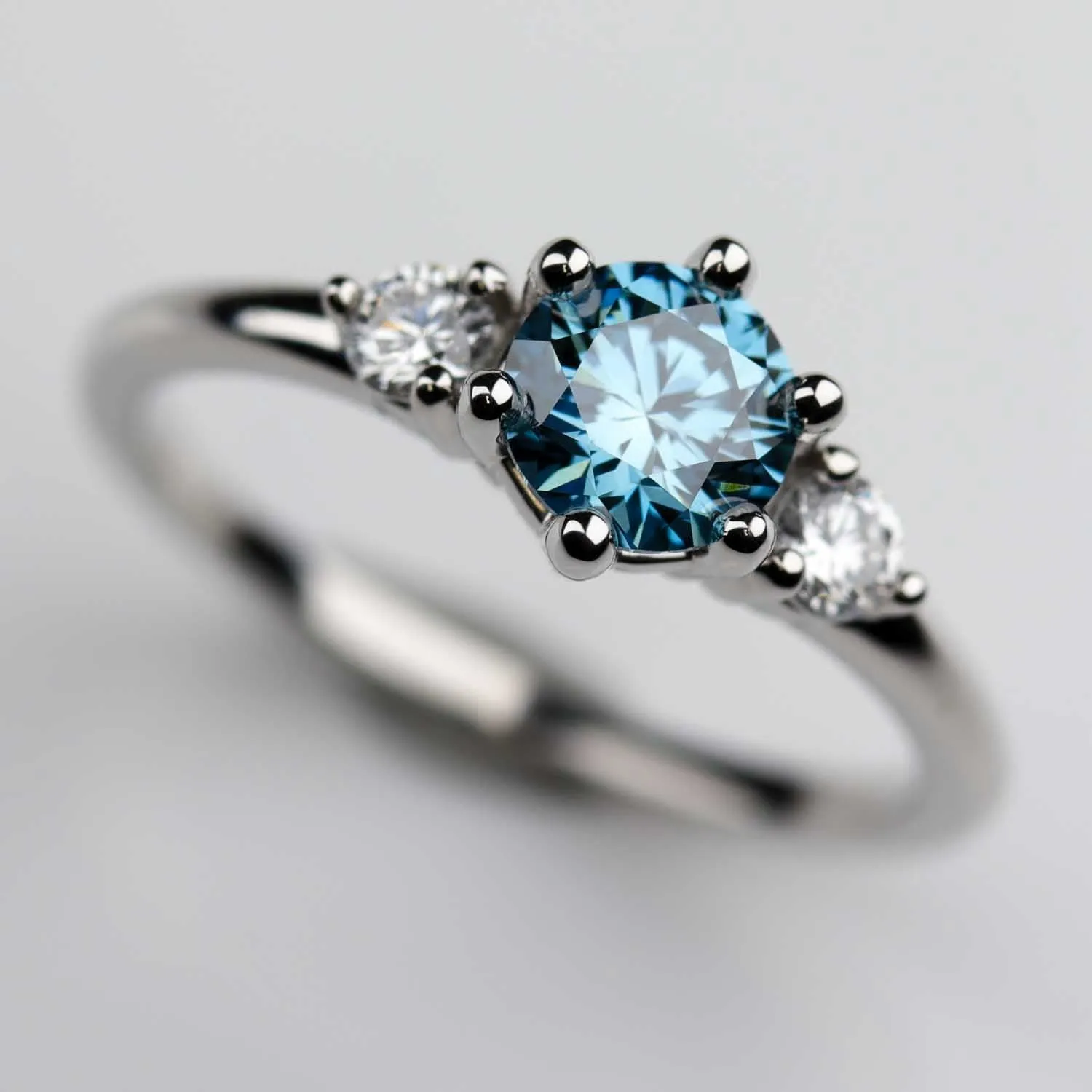 Three Stone Ring with Lab-grown Vivid Fancy Blue Diamond in Platinum