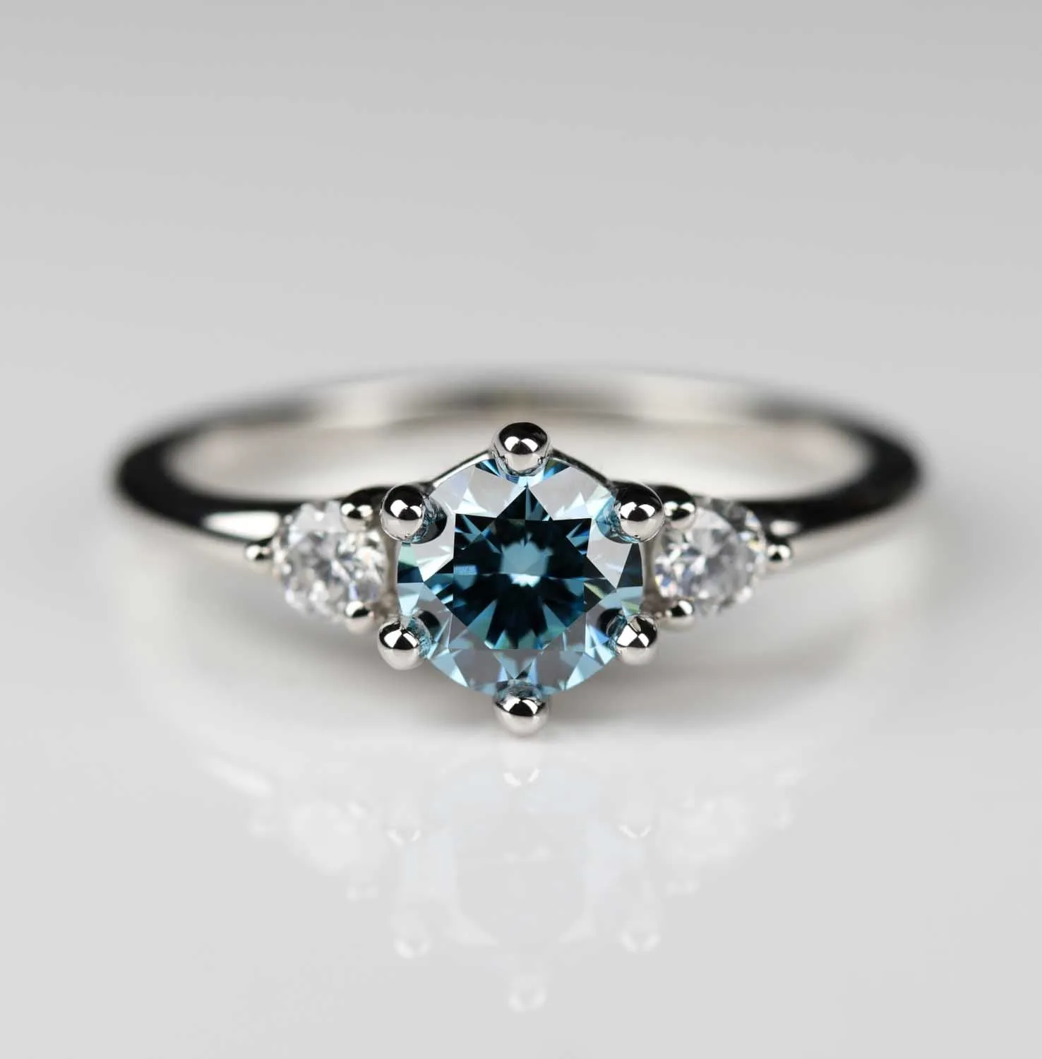 Three Stone Ring with Lab-grown Vivid Fancy Blue Diamond in Platinum